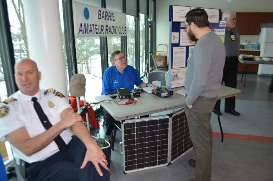 Al (VE3RRD) demonstrating a mobile radio station for attendees at the conference